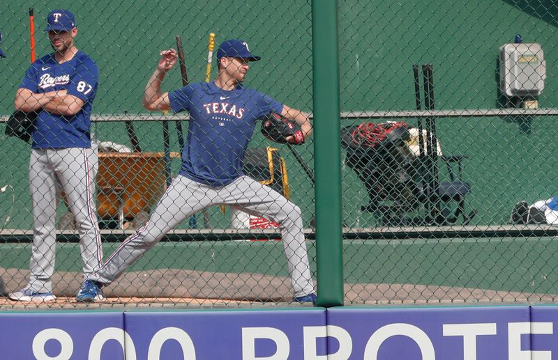 May 23, 2023; Pittsburgh, Pennsylvania, USA; Texas Rangers pitcher Jacob deGrom (right) simulates throwing in the bullpen before the game against the Pittsburgh Pirates at PNC Park. Mandatory Credit: Charles LeClaire-USA TODAY Sports