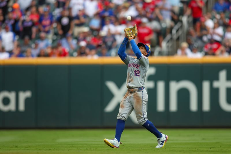 Sep 30, 2024; Atlanta, Georgia, USA; New York Mets shortstop Francisco Lindor (12) catches a pop fly against the Atlanta Braves in the ninth inning at Truist Park. Mandatory Credit: Brett Davis-Imagn Images