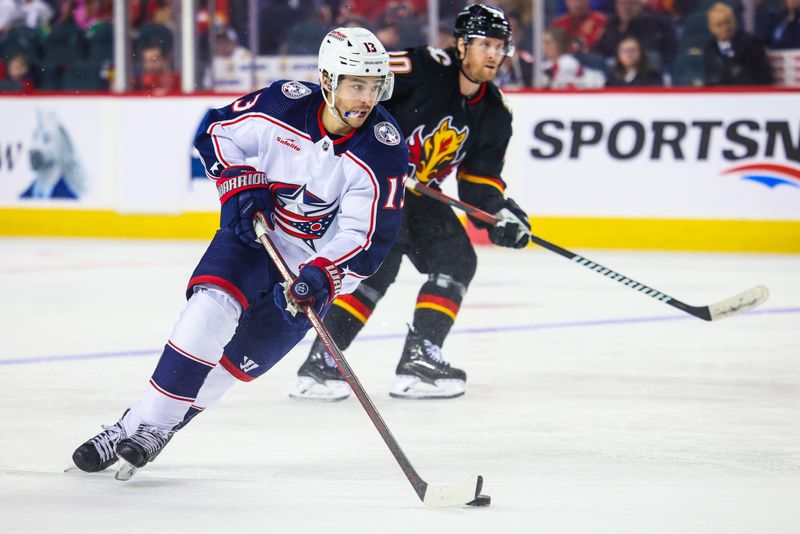 Jan 25, 2024; Calgary, Alberta, CAN; Columbus Blue Jackets left wing Johnny Gaudreau (13) controls the puck against the Calgary Flames during the second period at Scotiabank Saddledome. Mandatory Credit: Sergei Belski-USA TODAY Sports