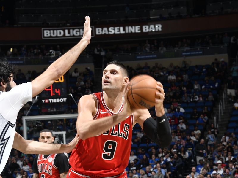 ORLANDO, FL - NOVEMBER 27: Nikola Vucevic #9 of the Chicago Bulls handles the ball during the game against the Orlando Magic on November 27, 2024 at Kia Center in Orlando, Florida. NOTE TO USER: User expressly acknowledges and agrees that, by downloading and or using this photograph, User is consenting to the terms and conditions of the Getty Images License Agreement. Mandatory Copyright Notice: Copyright 2024 NBAE (Photo by Fernando Medina/NBAE via Getty Images)