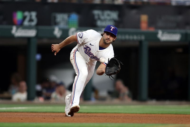 Jul 25, 2024; Arlington, Texas, USA;  Texas Rangers third base Josh Smith (8) fields a ground ball against the Chicago White Sox in the fourth inning at Globe Life Field. Mandatory Credit: Tim Heitman-USA TODAY Sports