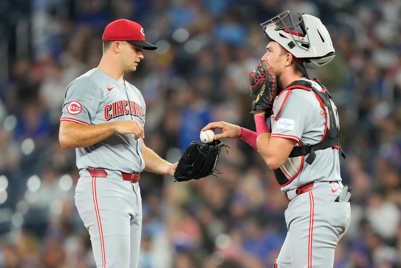 Aug 20, 2024; Toronto, Ontario, CAN; Cincinnati Reds catcher Tyler Stephenson (37) talks to starting pitcher Carson Spiers (68) after a one-run double by Toronto Blue Jays right fielder Addison Barger (not pictured) during the second inning at Rogers Centre. Mandatory Credit: John E. Sokolowski-USA TODAY Sports