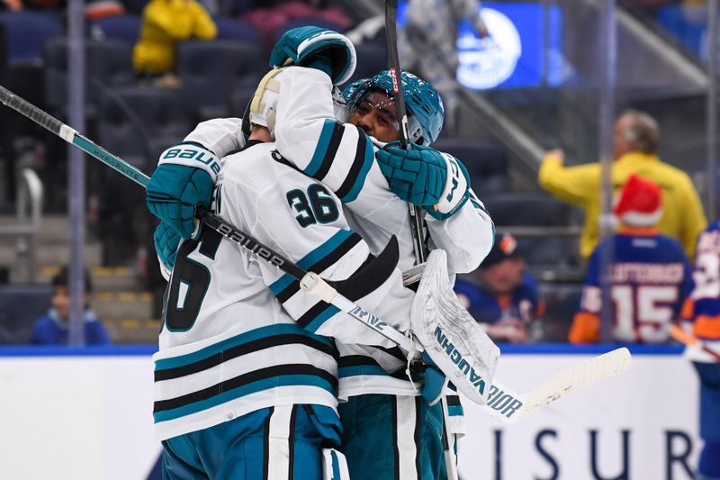 Dec 5, 2023; Elmont, New York, USA; San Jose Sharks left wing Anthony Duclair (10) celebrates the 5-4 victory in overtime against the New York Islanders with San Jose Sharks goaltender Kaapo Kahkonen (36) during the overtime period at UBS Arena. Mandatory Credit: Dennis Schneidler-USA TODAY Sports