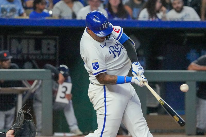 Sep 16, 2024; Kansas City, Missouri, USA;  Kansas City Royals catcher Salvador Perez (13) hits a single against the Detroit Tigers in the third inning at Kauffman Stadium. Mandatory Credit: Denny Medley-Imagn Images