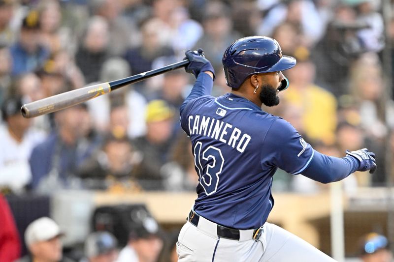 Apr 26, 2025; San Diego, California, USA; Tampa Bay Rays third baseman Junior Caminero (13) hits a double  during the fifth inning against the San Diego Padres at Petco Park. Mandatory Credit: Denis Poroy-Imagn Images