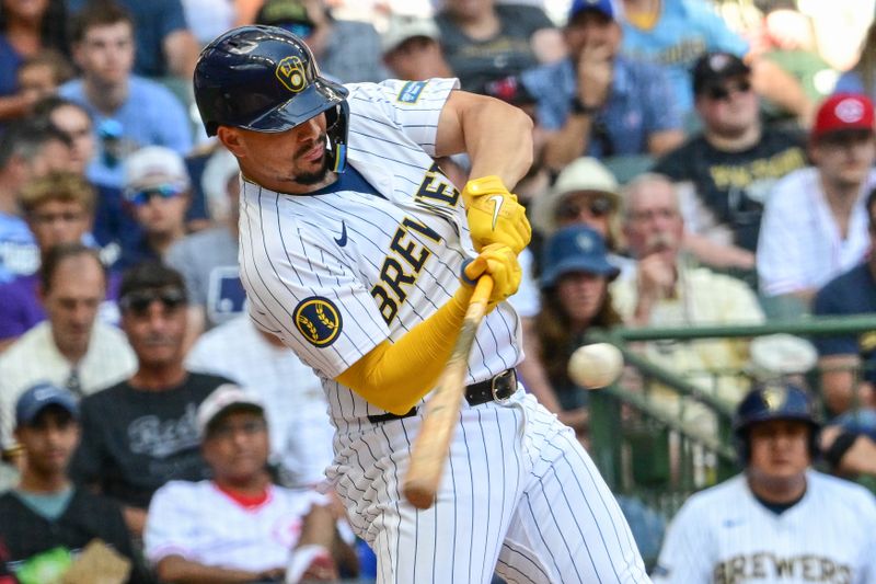 Aug 11, 2024; Milwaukee, Wisconsin, USA; Milwaukee Brewers shortstop Willy Adames (27) hits a single to drive in a run in the sixth inning against the Cincinnati Reds at American Family Field. Mandatory Credit: Benny Sieu-USA TODAY Sports