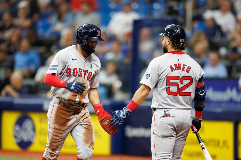 May 22, 2024; St. Petersburg, Florida, USA;  Boston Red Sox shortstop David Hamilton (70) celebrates eolith outfielder Wilyer Abreu (52) after scoring a run against the Tampa Bay Rays in the fifth inning at Tropicana Field. Mandatory Credit: Nathan Ray Seebeck-USA TODAY Sports