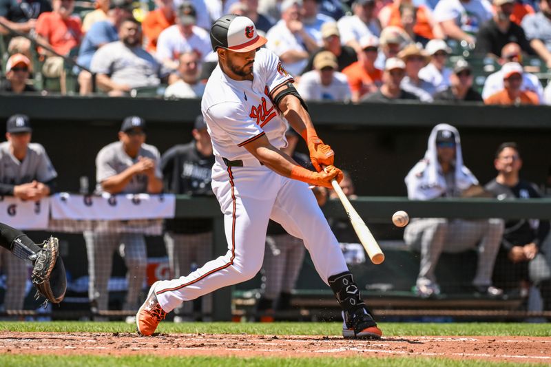 May 2, 2024; Baltimore, Maryland, USA;  Baltimore Orioles right fielder Anthony Santander (25) hits a second inning single against the New York Yankees at Oriole Park at Camden Yards. Mandatory Credit: James A. Pittman-USA TODAY Sports