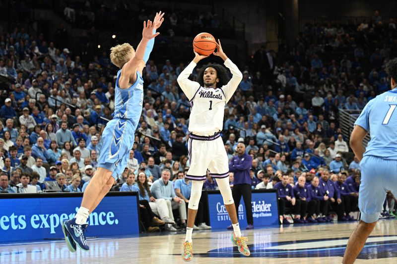 Dec 13, 2025; Omaha, Nebraska, USA;  Kansas State Wildcats guard Abdi Bashir Jr. (1) scores on a three point shot against Creighton Bluejays guard Ty Davis (9) during the first half at CHI Health Center Omaha. Mandatory Credit: Steven Branscombe-Imagn Images
