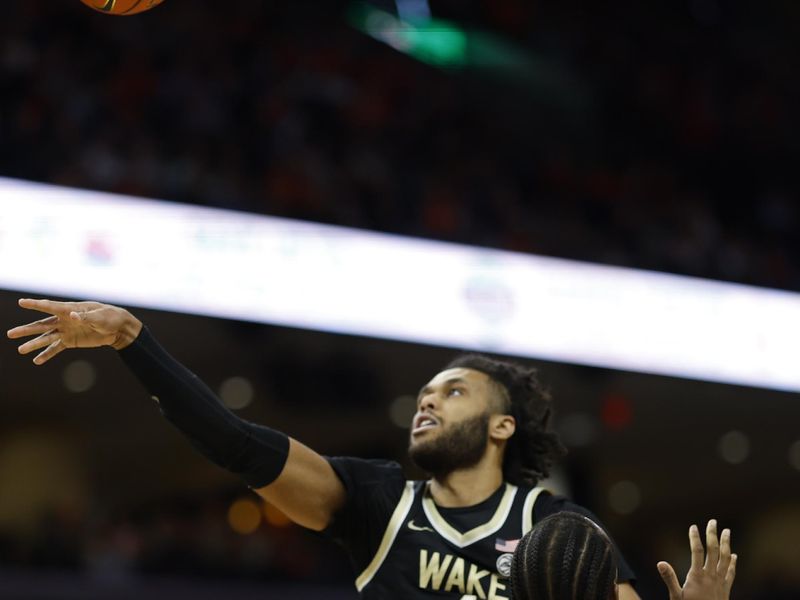 Feb 17, 2024; Charlottesville, Virginia, USA; Wake Forest Demon Deacons forward Efton Reid III (4) loses the ball as Virginia Cavaliers forward Jordan Minor (22) defends in the first half at John Paul Jones Arena. Mandatory Credit: Geoff Burke-USA TODAY Sports