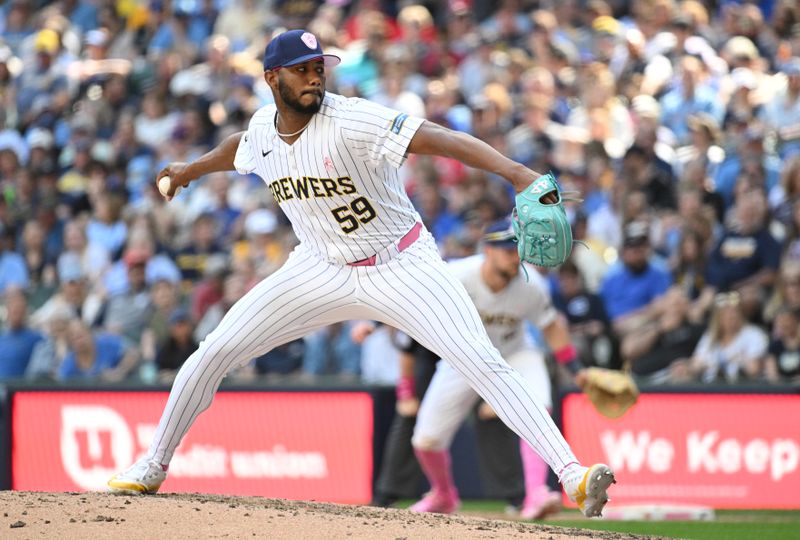 May 12, 2024; Milwaukee, Wisconsin, USA; Milwaukee Brewers pitcher Elvis Peguero (59) delivers a pitch against the St. Louis Cardinals in the seventh inning at American Family Field. Mandatory Credit: Michael McLoone-USA TODAY Sports