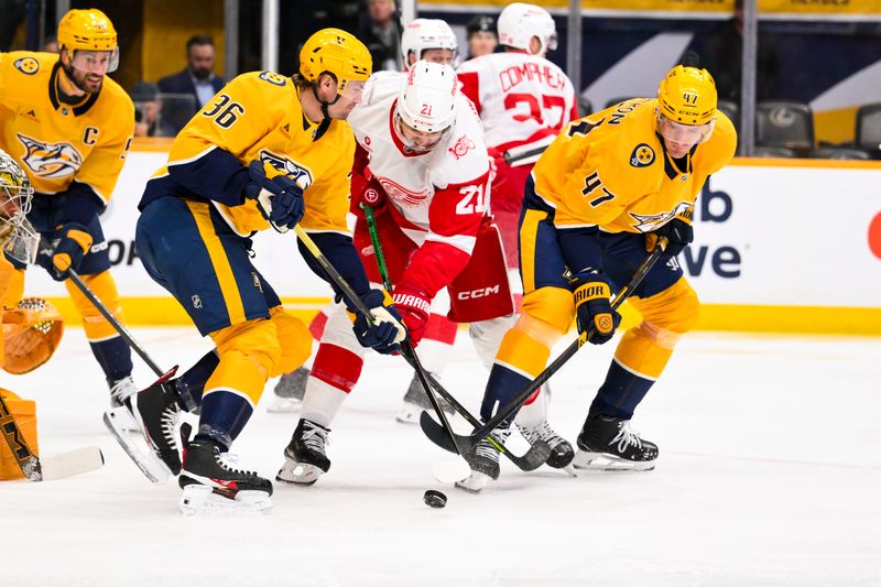 Mar 2, 2026; Nashville, Tennessee, USA;  Detroit Red Wings left wing James van Riemsdyk (21) and Nashville Predators right wing Michael McCarron (47) battle for the puck during the first period at Bridgestone Arena. Mandatory Credit: Steve Roberts-Imagn Images