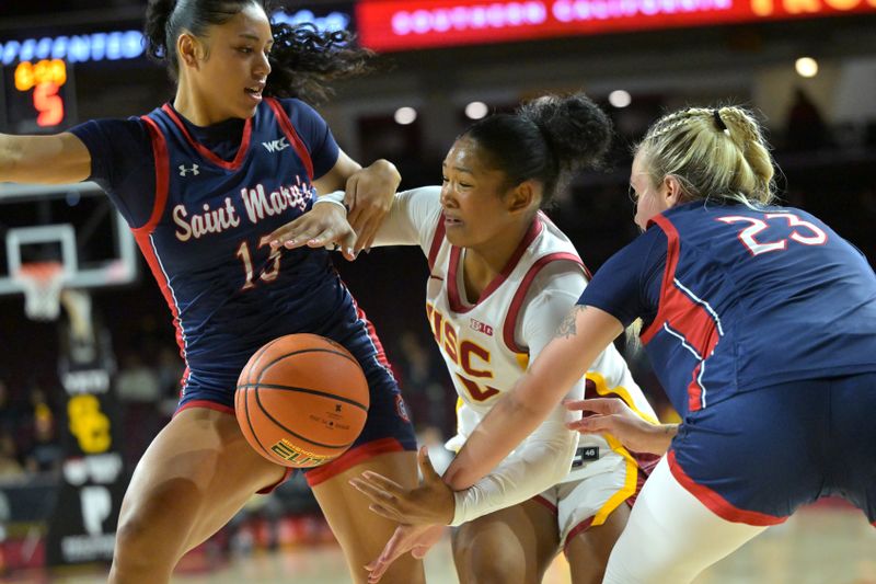 Dec 2, 2025; Los Angeles, California, USA;  USC Trojans guard Malia Samuels (10) is defended by Saint Mary's Gaels guard Malia Latu (13) and guard Addi Wedin (23) during the first half at Galen Center. Mandatory Credit: Jayne Kamin-Oncea-Imagn Images