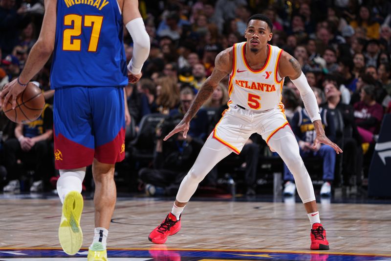 DENVER, CO - APRIL 6: Dejounte Murray #5 of the Atlanta Hawks plays defense during the game against the Denver Nuggets on April 6, 2024 at the Ball Arena in Denver, Colorado. NOTE TO USER: User expressly acknowledges and agrees that, by downloading and/or using this Photograph, user is consenting to the terms and conditions of the Getty Images License Agreement. Mandatory Copyright Notice: Copyright 2024 NBAE (Photo by Garrett Ellwood/NBAE via Getty Images)