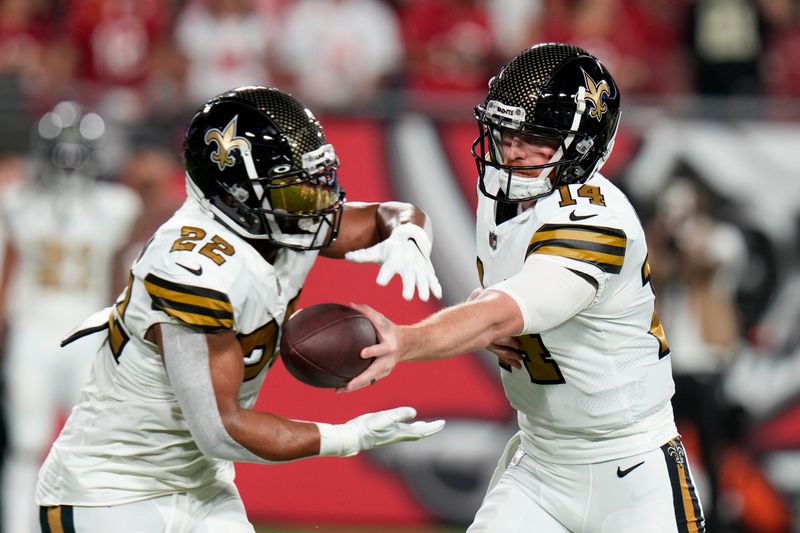 New Orleans Saints quarterback Andy Dalton (14) and running back Mark Ingram II (22) warm up before an NFL football game against the Tampa Bay Buccaneers in Tampa, Fla., Monday, Dec. 5, 2022. (AP Photo/Chris O'Meara)