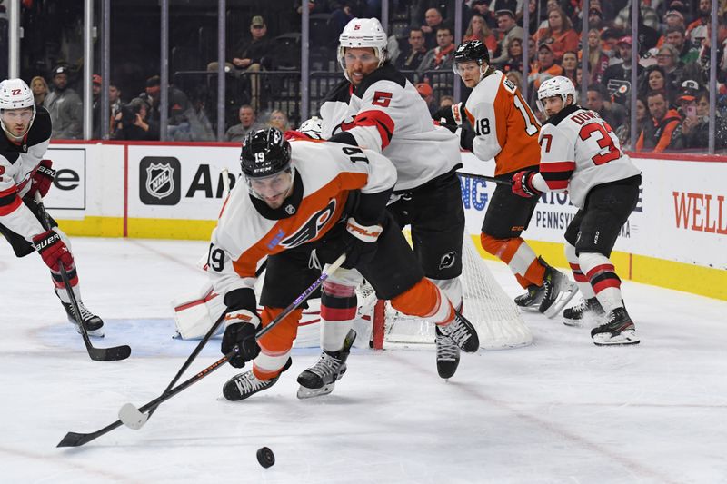 Jan 27, 2025; Philadelphia, Pennsylvania, USA; Philadelphia Flyers right wing Garnet Hathaway (19) is checked by New Jersey Devils defenseman Brenden Dillon (5) during the third period at Wells Fargo Center. Mandatory Credit: Eric Hartline-Imagn Images