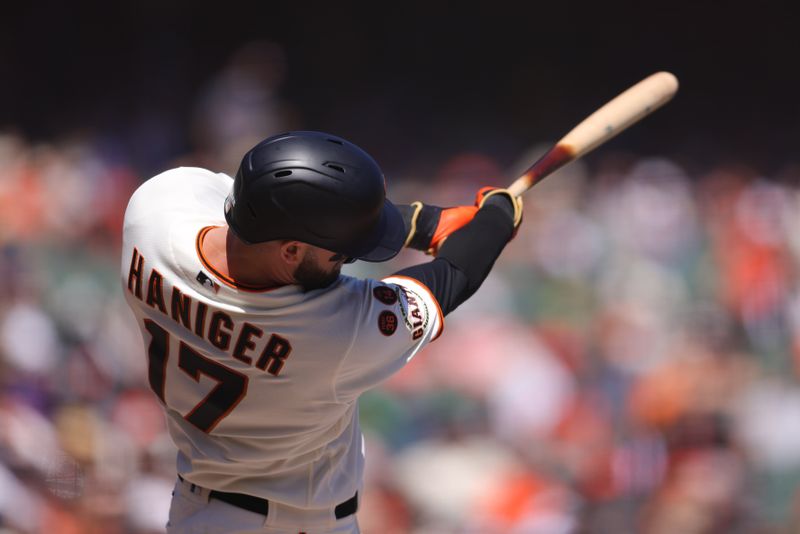 Sep 13, 2023; San Francisco, California, USA; San Francisco Giants left fielder Mitch Haniger (17) hits a single during the third inning against the Cleveland Guardians at Oracle Park. Mandatory Credit: Sergio Estrada-USA TODAY Sports