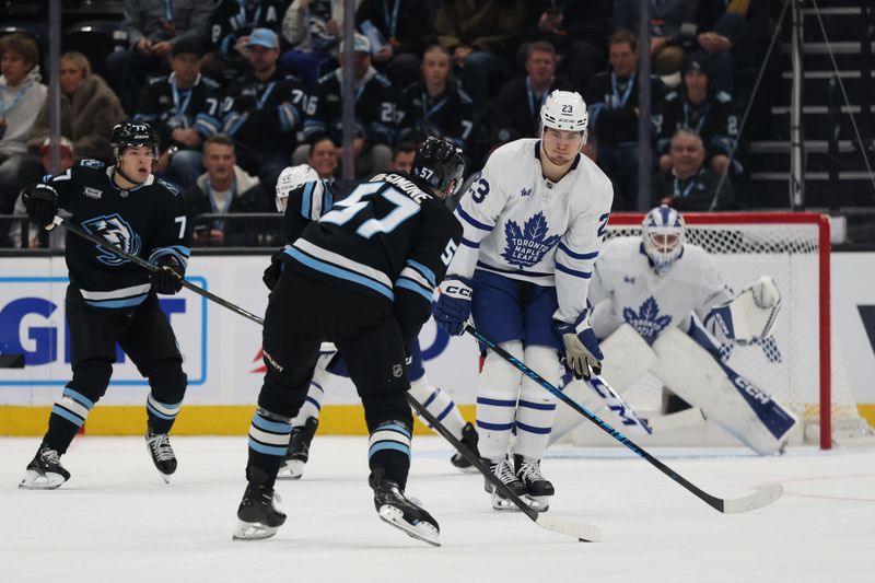 Jan 13, 2026; Salt Lake City, Utah, USA; Utah Mammoth defenseman Nick DeSimone (57) shoots against Toronto Maple Leafs left wing Matthew Knies (23) during the first period at Delta Center. Mandatory Credit: Rob Gray-Imagn Images