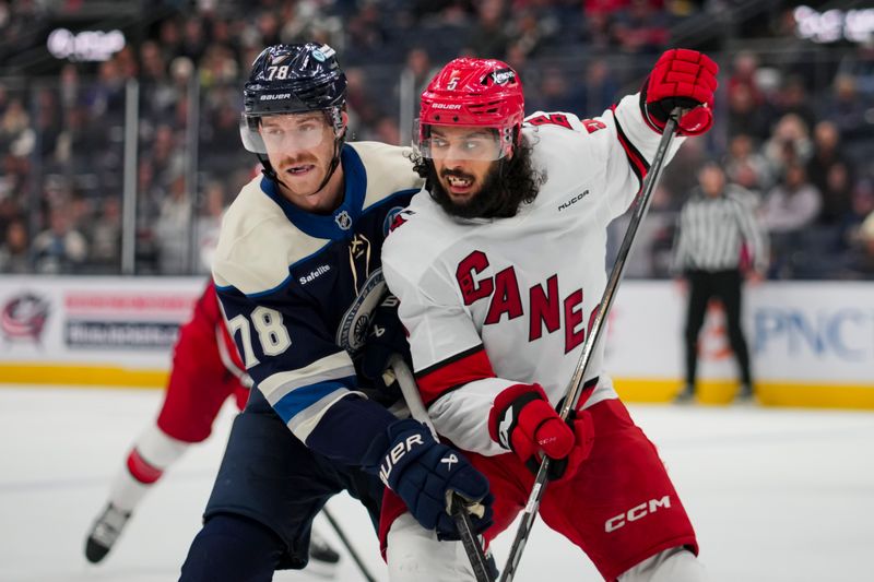 Nov 23, 2024; Columbus, Ohio, USA;  Columbus Blue Jackets defenseman Damon Severson (78) skates against Carolina Hurricanes defenseman Jalen Chatfield (5) in the second period at Nationwide Arena. Mandatory Credit: Aaron Doster-Imagn Images