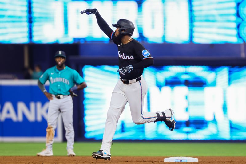 Jun 21, 2024; Miami, Florida, USA; Miami Marlins left fielder Bryan De La Cruz (14) circles the bases after hitting a home run against the Seattle Mariners during the sixth inning at loanDepot Park. Mandatory Credit: Sam Navarro-USA TODAY Sports