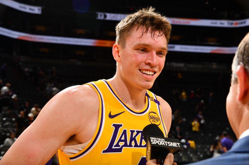 PHOENIX, AZ - OCTOBER 17: Dalton Knecht #4 of the Los Angeles Lakers talks to the media after the game against the Phoenix Suns during a NBA Preseason game on October 17, 2024 at Footprint Center in Phoenix, Arizona. NOTE TO USER: User expressly acknowledges and agrees that, by downloading and or using this photograph, user is consenting to the terms and conditions of the Getty Images License Agreement. Mandatory Copyright Notice: Copyright 2024 NBAE (Photo by Barry Gossage/NBAE via Getty Images)