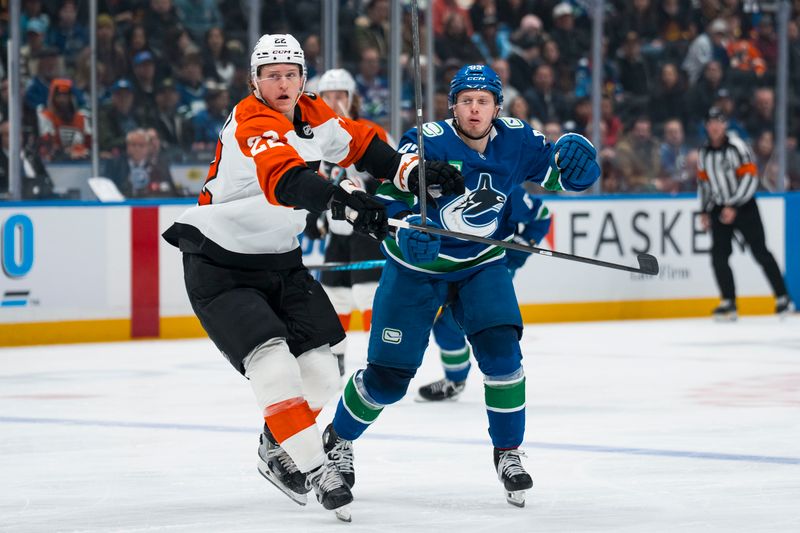 Dec 30, 2025; Vancouver, British Columbia, CAN; Philadelphia Flyers forward Christian Dvorak (22) battles with Vancouver Canucks forward Marco Rossi (93) in the second period at Rogers Arena. Mandatory Credit: Bob Frid-Imagn Images