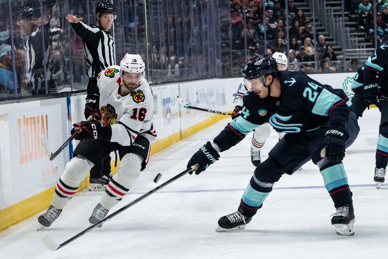 Nov 14, 2024; Seattle, Washington, USA;  Chicago Blackhawks forward Jason Dickinson (16) and Seattle Kraken defenseman Jamie Oleksiak (24) battle for the puck during the second period at Climate Pledge Arena. Mandatory Credit: Stephen Brashear-Imagn Images