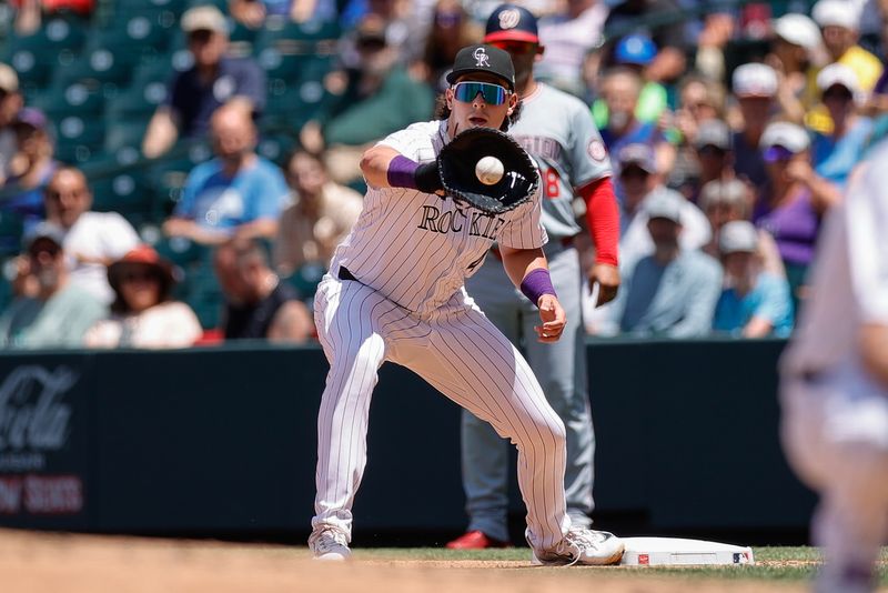 Jun 23, 2024; Denver, Colorado, USA; Colorado Rockies first baseman Michael Toglia (4) fields a throw at first for an out in the third inning against the Washington Nationals at Coors Field. Mandatory Credit: Isaiah J. Downing-USA TODAY Sports