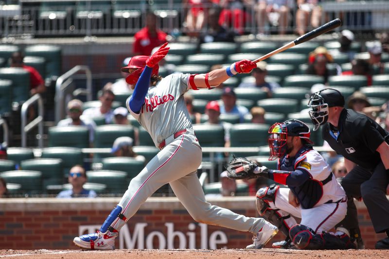 Jul 7, 2024; Atlanta, Georgia, USA; Philadelphia Phillies third baseman Alec Bohm (28) hits a double against the Atlanta Braves in the sixth inning at Truist Park. Mandatory Credit: Brett Davis-USA TODAY Sports