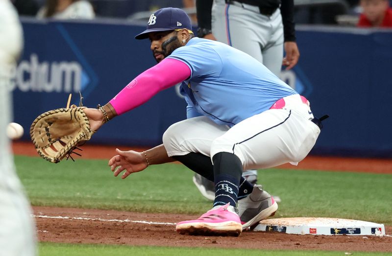 wJul 30, 2024; St. Petersburg, Florida, USA; Tampa Bay Rays first base Yandy Díaz (2) catches the ball for an out against the Miami Marlins during the third inning at Tropicana Field. Mandatory Credit: Kim Klement Neitzel-USA TODAY Sports