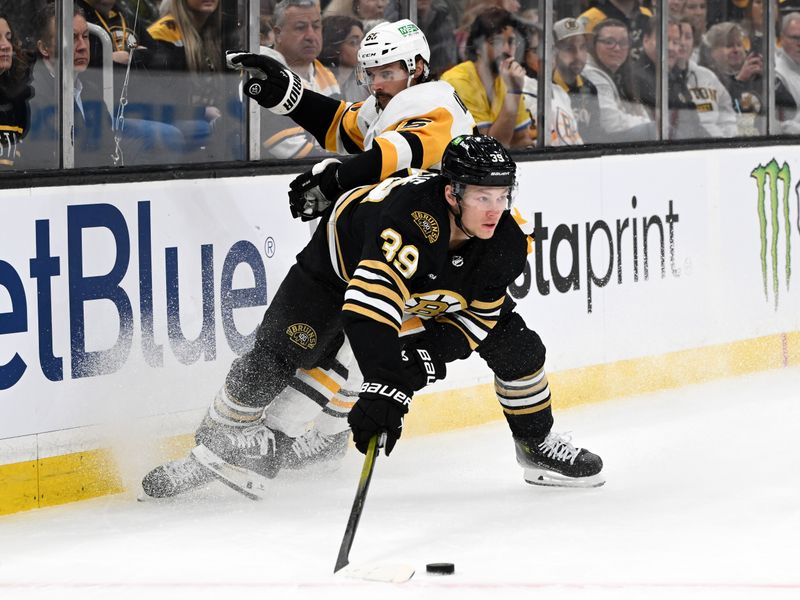 Mar 9, 2024; Boston, Massachusetts, USA; Boston Bruins center Morgan Geekie (39) controls the puck against Pittsburgh Penguins defenseman Erik Karlsson (65) during the first period at the TD Garden. Mandatory Credit: Brian Fluharty-USA TODAY Sports