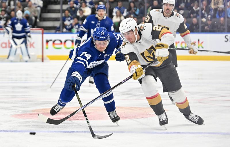 Feb 27, 2024; Toronto, Ontario, CAN;  Vegas Golden Knights defenseman Zach Whitecloud (2) clears the puck away from Toronto Maple Leafs forward Bobby McMann (74) in the third period at Scotiabank Arena. Mandatory Credit: Dan Hamilton-USA TODAY Sports