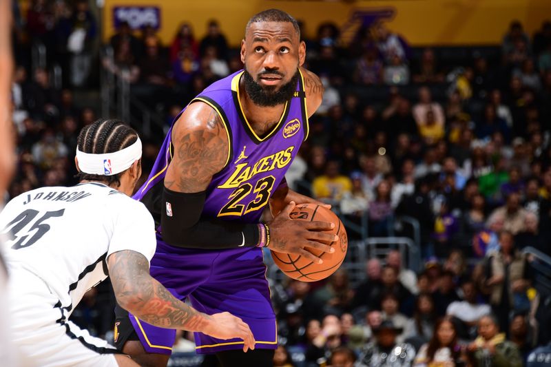 LOS ANGELES, CA - JANUARY 17:  LeBron James #23 of the Los Angeles Lakers looks to pass the ball during the game against the Brooklyn Nets on January 17, 2025 at Crypto.Com Arena in Los Angeles, California. NOTE TO USER: User expressly acknowledges and agrees that, by downloading and/or using this Photograph, user is consenting to the terms and conditions of the Getty Images License Agreement. Mandatory Copyright Notice: Copyright 2025 NBAE (Photo by Adam Pantozzi/NBAE via Getty Images)