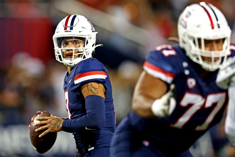 Oct 8, 2022; Tucson, Arizona, USA; Arizona Wildcats quarterback Jayden de Laura (7) drops back to pass during the first half against the Oregon Ducks at Arizona Stadium. Mandatory Credit: Mark J. Rebilas-USA TODAY Sports