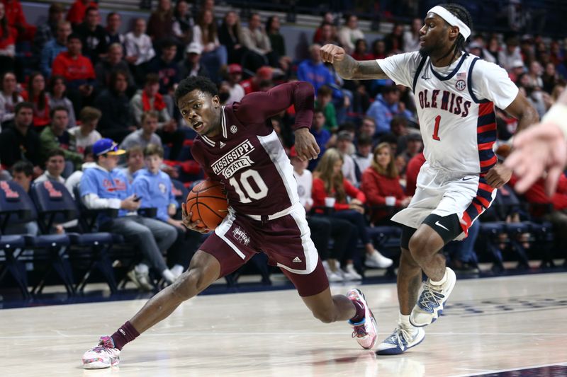 Feb 18, 2023; Oxford, Mississippi, USA; Mississippi State Bulldogs guard Dashawn Davis (10) drives to the basket as Mississippi Rebels guard Amaree Abram (1) defends during the first half at The Sandy and John Black Pavilion at Ole Miss. Mandatory Credit: Petre Thomas-USA TODAY Sports