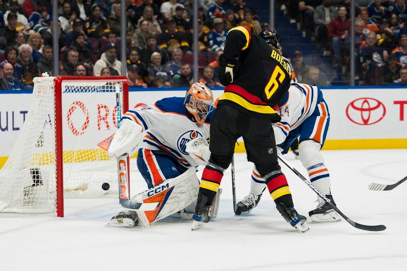 Nov 6, 2023; Vancouver, British Columbia, CAN; Edmonton Oilers defenseman Mattias Ekholm (14) battles with Vancouver Canucks forward Brock Boeser (6) as Boesser scores scores on Edmonton Oilers goalie Stuart Skinner (74) in the first period at Rogers Arena. Mandatory Credit: Bob Frid-USA TODAY Sports