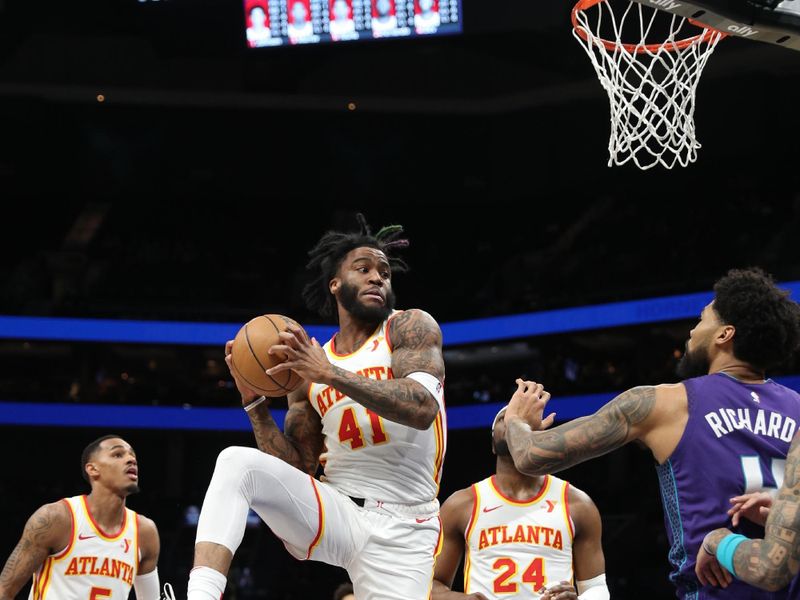 CHARLOTTE, NC - FEBRUARY 14: Saddiq Bey #41 of the Atlanta Hawks rebounds the ball during the game against the Charlotte Hornets on February 14, 2024 at Spectrum Center in Charlotte, North Carolina. NOTE TO USER: User expressly acknowledges and agrees that, by downloading and or using this photograph, User is consenting to the terms and conditions of the Getty Images License Agreement.  Mandatory Copyright Notice:  Copyright 2024 NBAE (Photo by Brock Williams-Smith/NBAE via Getty Images)