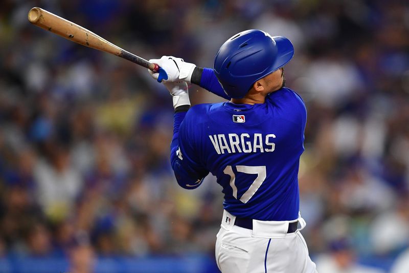 Jul 6, 2023; Los Angeles, California, USA; Los Angeles Dodgers second baseman Miguel Vargas (17) hits a double against the Pittsburgh Pirates during the fifth inning at Dodger Stadium. Mandatory Credit: Gary A. Vasquez-USA TODAY Sports