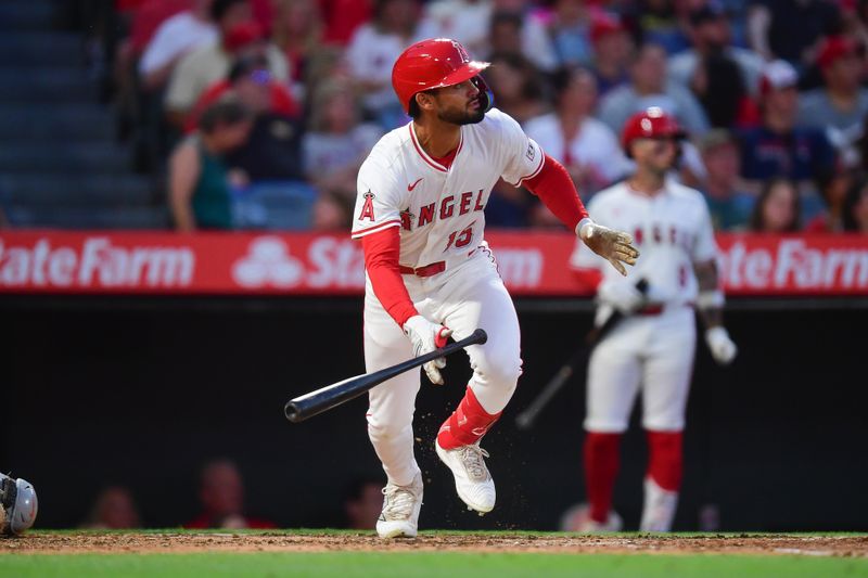 May 10, 2025; Anaheim, California, USA; Los Angeles Angels left fielder Matthew Lugo (15) hits an RBI triple for his first major league hit against the Baltimore Orioles during the fourth inning at Angel Stadium. Mandatory Credit: Gary A. Vasquez-Imagn Images