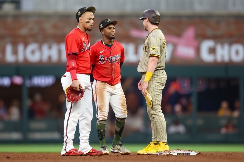 May 17, 2024; Atlanta, Georgia, USA; Atlanta Braves shortstop Orlando Arcia (11) and second baseman Ozzie Albies (1) talk to San Diego Padres first baseman Jake Cronenworth (9) in the third inning at Truist Park. Mandatory Credit: Brett Davis-USA TODAY Sports