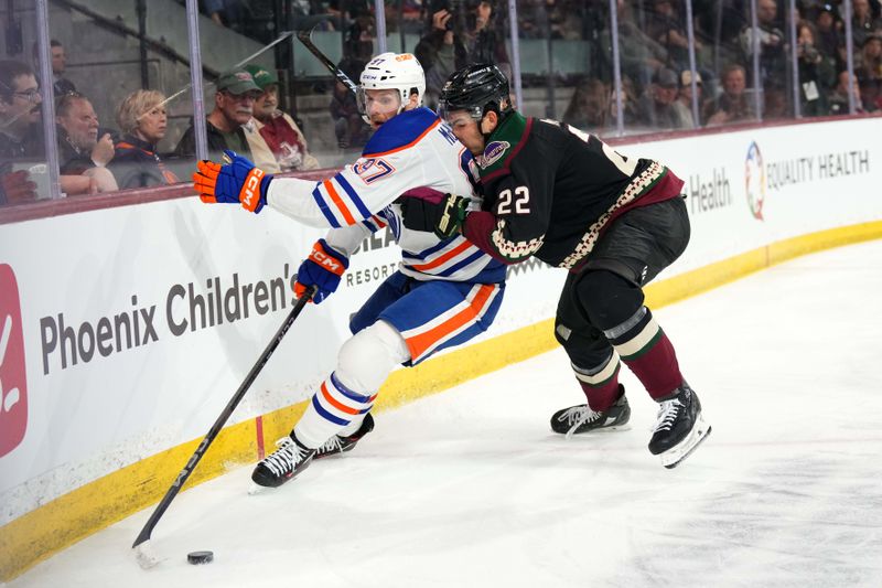 Feb 19, 2024; Tempe, Arizona, USA; Arizona Coyotes center Jack McBain (22) checks Edmonton Oilers center Connor McDavid (97) during the second period at Mullett Arena. Mandatory Credit: Joe Camporeale-USA TODAY Sports