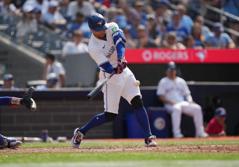 Jul 27, 2024; Toronto, Ontario, CAN; Toronto Blue Jays right fielder George Springer (4) hits a single against the Texas Rangers during the sixth inning at Rogers Centre. Mandatory Credit: Nick Turchiaro-USA TODAY Sports