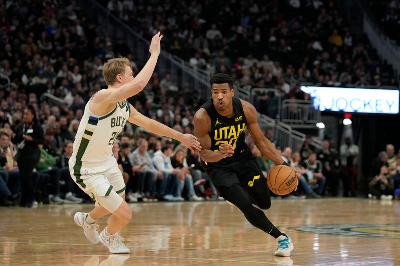 MILWAUKEE, WISCONSIN - JANUARY 08: Ochai Agbaji #30 of the Utah Jazz dribbles the ball against AJ Green #20 of the Milwaukee Bucks in the first half at Fiserv Forum on January 08, 2024 in Milwaukee, Wisconsin. NOTE TO USER: User expressly acknowledges and agrees that, by downloading and or using this photograph, User is consenting to the terms and conditions of the Getty Images License Agreement. (Photo by Patrick McDermott/Getty Images)