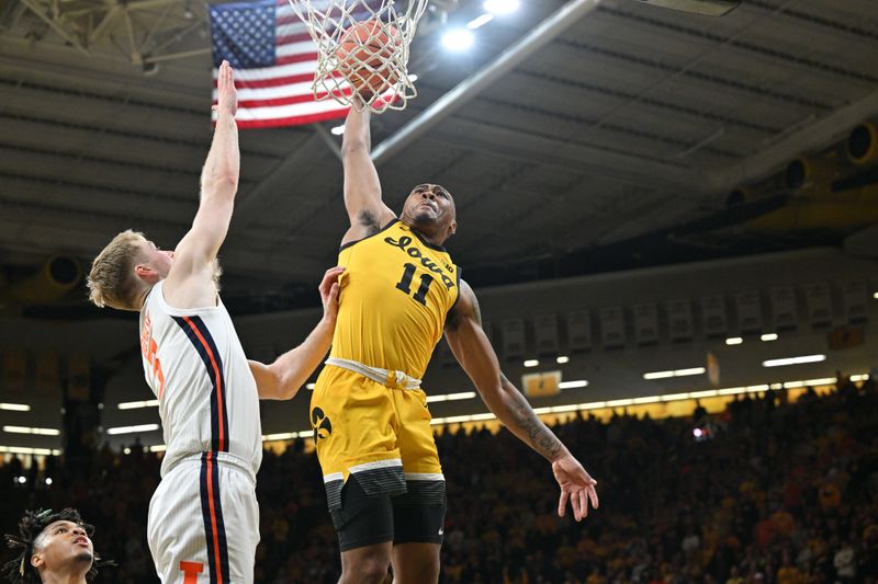 Mar 10, 2024; Iowa City, Iowa, USA; Iowa Hawkeyes guard Tony Perkins (11) goes to the basket as Illinois Fighting Illini forward Marcus Domask (3) defends during the second half at Carver-Hawkeye Arena. Perkins would miss this shot and turn the ball over to the Illini. Mandatory Credit: Jeffrey Becker-USA TODAY Sports