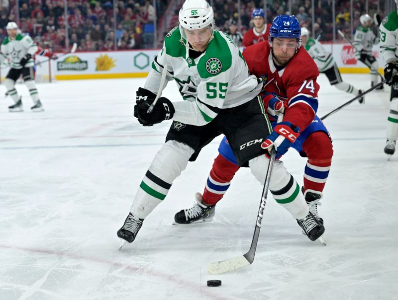 Feb 10, 2024; Montreal, Quebec, CAN; Dallas Stars defenseman Thomas Harley (55) controls the puck against Montreal Canadiens  forward Brandon Gignac (74) during the second period at the Bell Centre. Mandatory Credit: Eric Bolte-USA TODAY Sports