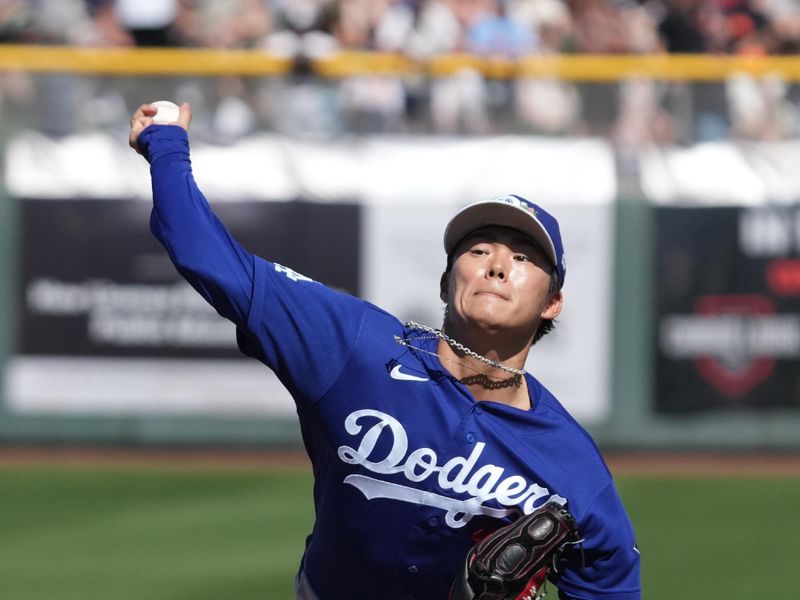 Feb 27, 2026; Scottsdale, Arizona, USA; Los Angeles Dodgers pitcher Yoshinobu Yamamoto (18) throws against the San Francisco Giants in the first inning at Scottsdale Stadium. Mandatory Credit: Rick Scuteri-Imagn Images
