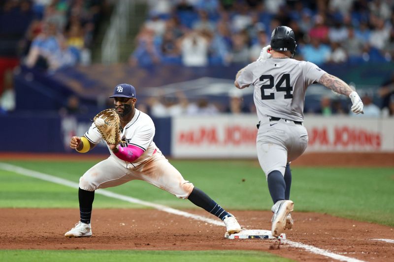 Jul 11, 2024; St. Petersburg, Florida, USA; New York Yankees outfielder Alex Verdugo (24) is thrown out at first base by Tampa Bay Rays first baseman Yandy Diaz (2) in the ninth inning at Tropicana Field. Mandatory Credit: Nathan Ray Seebeck-USA TODAY Sports