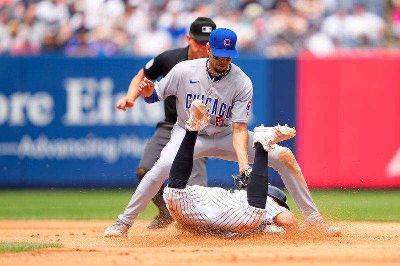 Jul 8, 2023; Bronx, New York, USA; Chicago Cubs second baseman Christopher Morel (5) tags out New York Yankees shortstop Anthony Volpe (11) after being picked off at first base during the fourth inning at Yankee Stadium. Mandatory Credit: Gregory Fisher-USA TODAY Sports