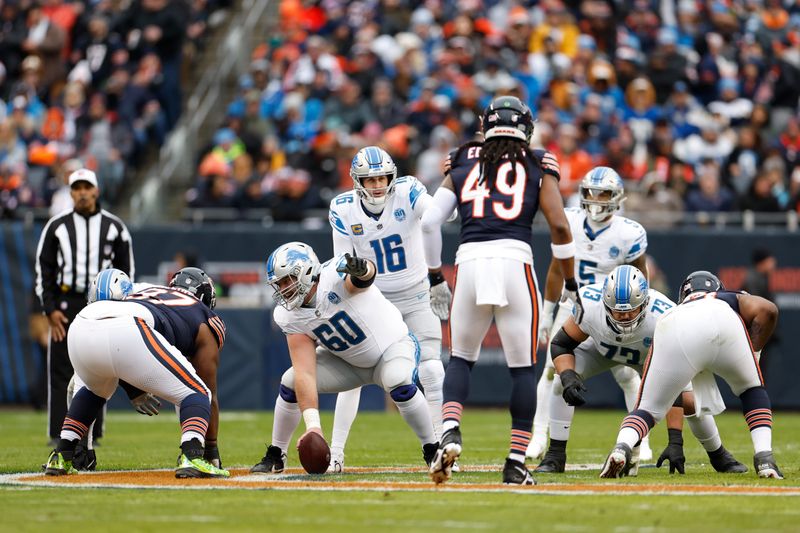 Detroit Lions guard Graham Glasgow (60) signals during the first half of an NFL football game against the Chicago Bears, Sunday, Dec. 10, 2023, in Chicago. (AP Photo/Kamil Krzaczynski)