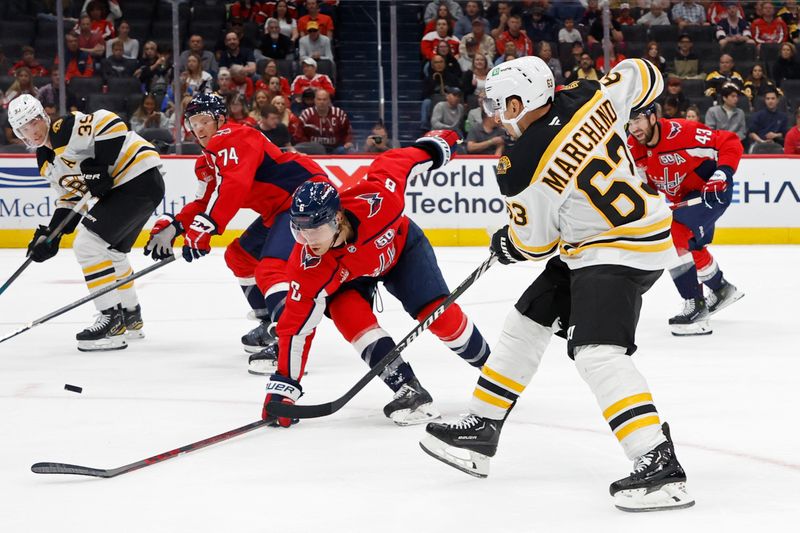 Oct 5, 2024; Washington, District of Columbia, USA; Boston Bruins left wing Brad Marchand (63) passes the puck to Boston Bruins center Morgan Geekie (39) as Capitals defenseman Jakob Chychrun (6) defends in the second period at Capital One Arena. Mandatory Credit: Geoff Burke-Imagn Images